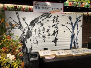 ステージ上、書道パフォーマンスが終わって書きあがった書